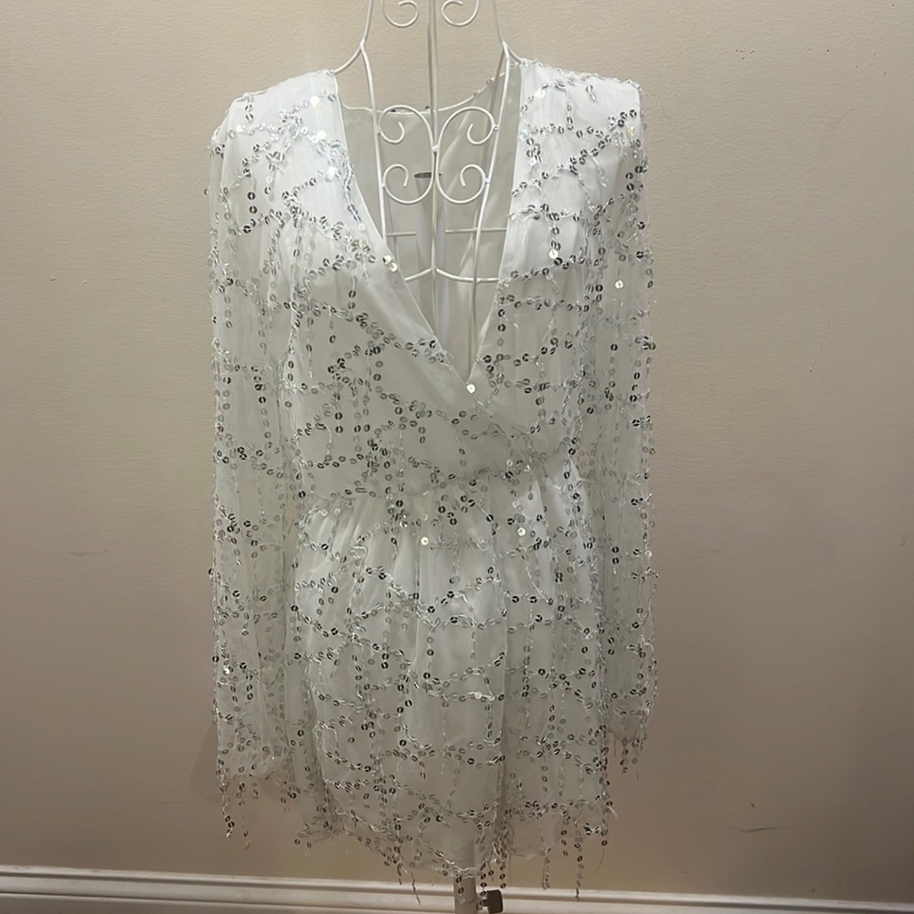 A white romper with silver sequins